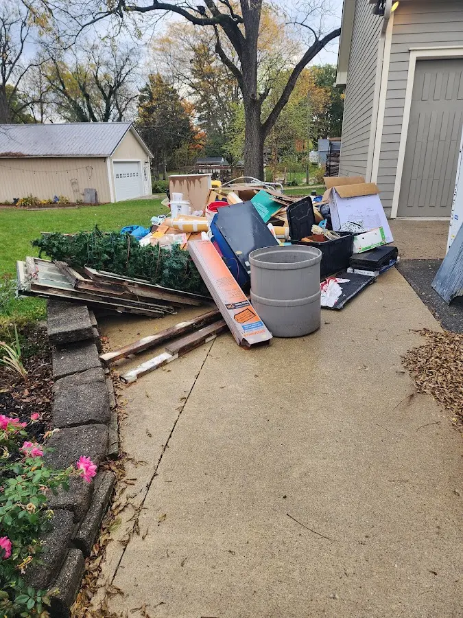 Dumpster being loaded with debris for Estate Cleanout Dumpster Rental in Algona